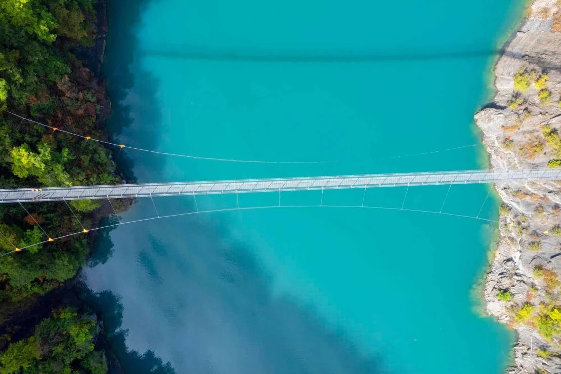 A bridge connecting two shores over turquoise water
