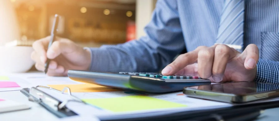 Illustration of an accountant working at a computer with business tracking screens.